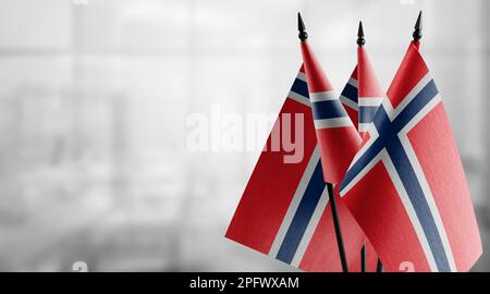 Small flags of the Norway on an abstract blurry background Stock Photo ...