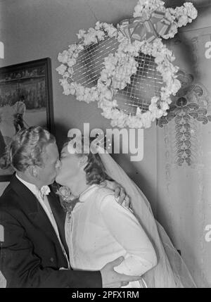 Kissing in the 1940s. Newlyweds couple Rohlsson during a wedding kiss.     Sweden 1941 Kristoffersson Ref 199-3 Stock Photo