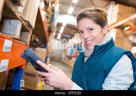warehouse female worker scanning barcodes on boxes Stock Photo