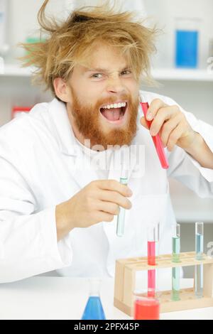 crazy alchemist checks the test tubes Stock Photo