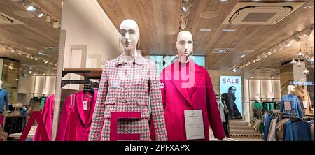 Austria, Vienna - January 9, 2023: Women's outerwear store of german brand Hallhuber. Female mannequins dressed in coats Stock Photo