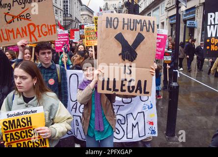 London, UK. 18th March 2023. Protesters in Haymarket. Thousands of people marched from BBC headquarters through Central London in support of refugees, and in protest against racism and the UK Government's Illegal Migration Bill. Stock Photo