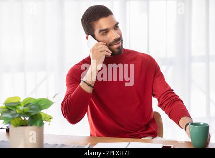 Middle eastern businessman working at office, have phone conversation Stock Photo