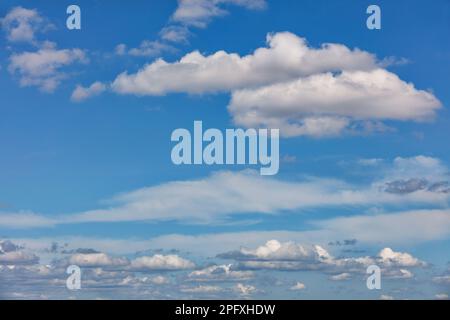 Elegant white small clouds in the daytime against the blue sky on a sunny day. Stock Photo