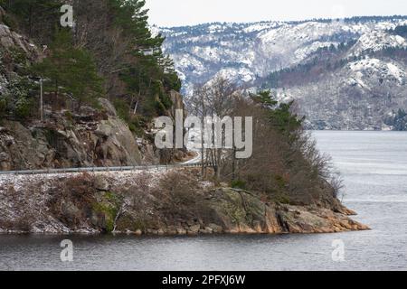 Narrow road carved out of a steep cliffside Stock Photo