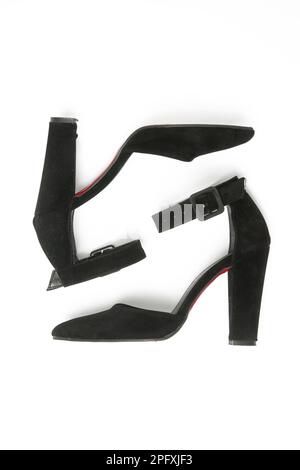 Black women's pointed toe pumps with block high heels and ankle strap, studio shot isolated on white background Stock Photo