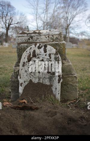 Vintage traditional stone gravestone with a blank epitaph and room for text. Stock Photo