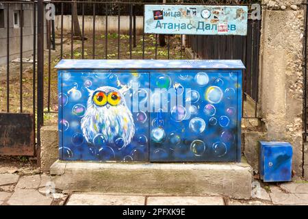 Street art painting of an owl in blue on street cabinet in Sofia, Bulgaria Stock Photo