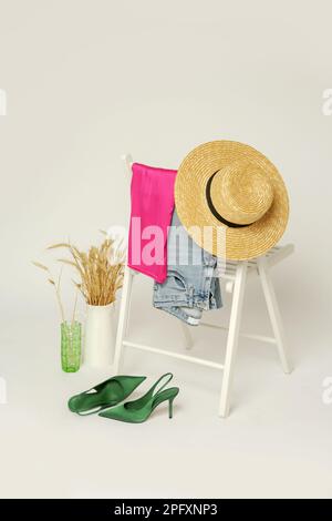 Clothes on a chair. Product photography, fashion still life. Spring summer outfits. Stock Photo
