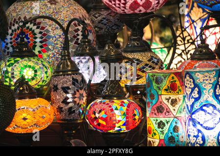 Middle Eastern lambas of different colors and sizes are hanging in the bazaar. Bright traditional Arabic and Turkish lanterns made of metal and glass Stock Photo