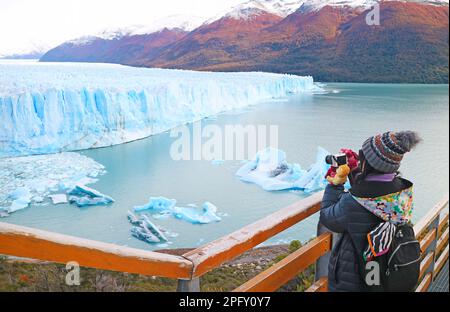 Female Visitor Shooting Photos of Perito Moreno Glacier, an Incredible UNESCO World Heritage Site in Patagonia, Argentina, South America Stock Photo