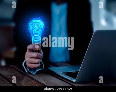 Artificial intelligence technology concept. Glow digital brain circuit, AI chip and gears icon in light bulb on networks, hold by business person. Cre Stock Photo
