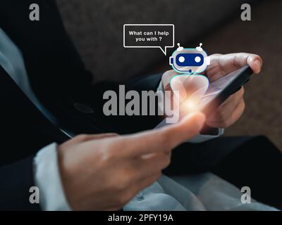Artificial intelligence, AI chat bot technology concept. Hologram of digital smart robot with speech bubble virtual on phone in hands, robot applicati Stock Photo