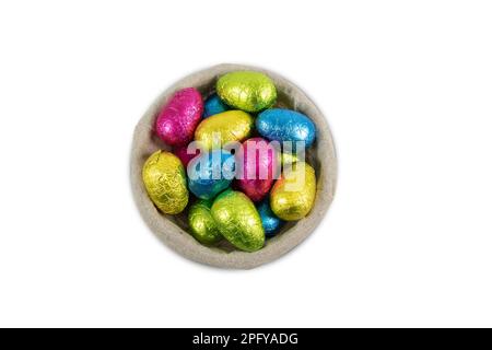 Chocolate Easter eggs in a basket isolated on white. Stock Photo