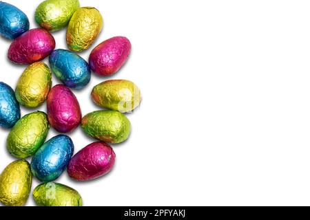 Chocolate Easter eggs wrapped in colorful foil isolated on white background. Stock Photo
