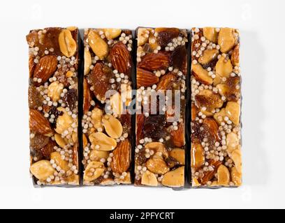 Top view of delicious four energy bars with nuts and seeds isolated on white background Stock Photo