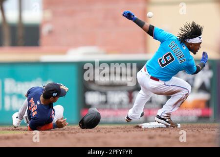 Miami Marlins' Jean Segura runs to beat the throw by Philadelphia Phillies  second baseman Bryson Stott but is out at the plate during the eighth  inning of a baseball game, Sunday, July