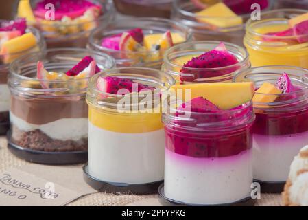 Panna cotta in a glass with various fruits at the confectionery stand at the farmers street food market in Karlin, Prague. Stock Photo