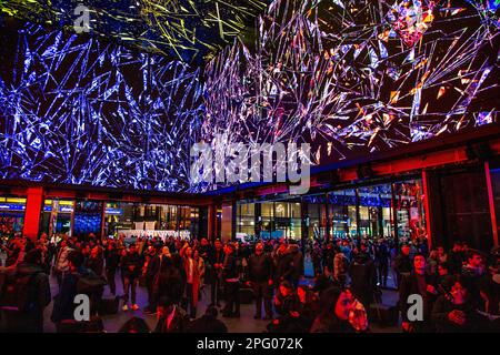 People looking at 'A Step Beyond' by light artist Rupert Newman at the Now Building, Tottenham Court Road, London, UK Stock Photo