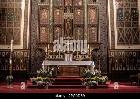 St. Mark's Catholic Church with Easter flowers around the altar; Jesus Christ of the Universe central figure, St. Paul, Minnesota USA. Stock Photo