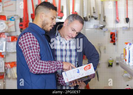 seller advising client in hardware store Stock Photo