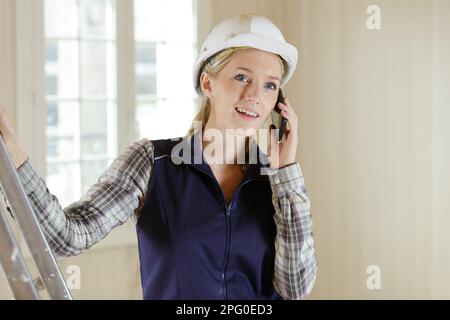 young smiling builder on the phone Stock Photo