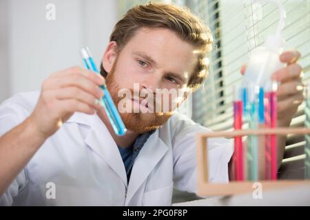 young investigator checking test tubes Stock Photo