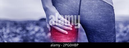 Red area on back of leg indicating pain or muscle injury on sports athlete .Young woman holding painful thigh in blue toned filter banner panorama Stock Photo