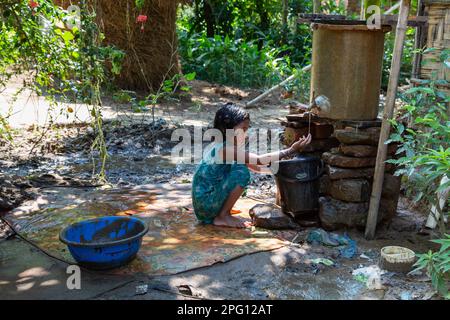 'Simple joys in the village: A little girl plays in tubewell water.' Photo Credit: Ripon Abraham Tolentino Stock Photo