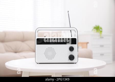 Stylish white radio on table in living room Stock Photo