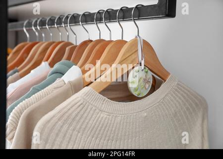 Beautiful scented sachet and clothes hanging in wardrobe Stock Photo ...