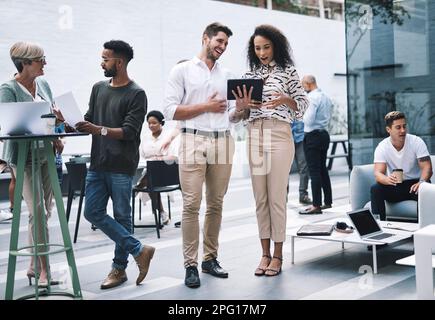 Make them laugh and youll make a lasting impression. a young businessman and businesswoman using a digital tablet at a conference. Stock Photo