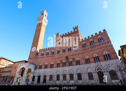 High tower called TORRE DEL MANGIA and the town hall of Siena in the main square of the city in Italy Stock Photo