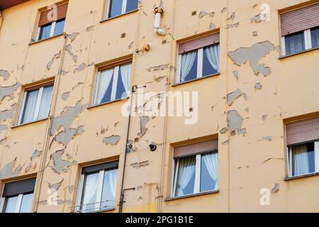 Peeling paint on the wall of a damaged residential building Stock Photo