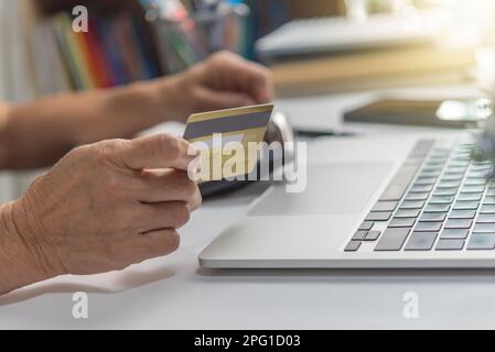 woman using laptop shopping purchasing online, paying by credit card, making payment, checking balance, browsing internet banking service. Stock Photo