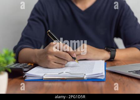 Businessman checking document data accounting and paperwork tax finance or reading law information.Business report contract signature on desk. Stock Photo