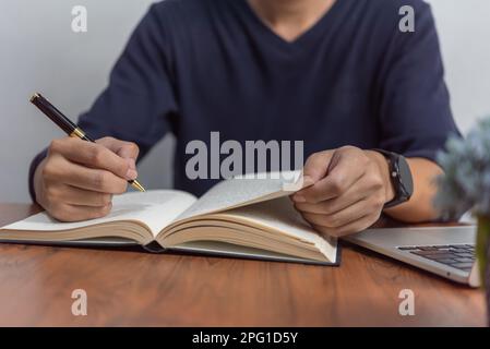 learning online class by using laptop computer and writing notebook at workplace, Education development or knowledge improvement concept. Stock Photo