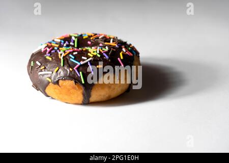 Colourful donuts on white background. Stock Photo