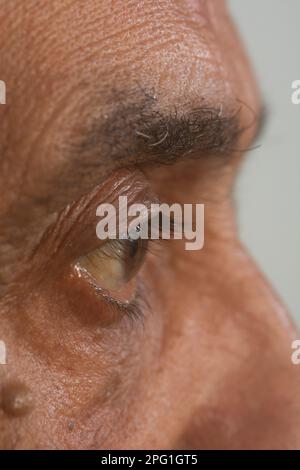 Close up of old mans eye looking away Stock Photo