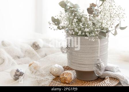 Light Easter composition with Easter eggs and gypsophila flowers. Stock Photo