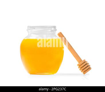 Fresh honey in a jar wooden dipper on a white isolated background. Stock Photo
