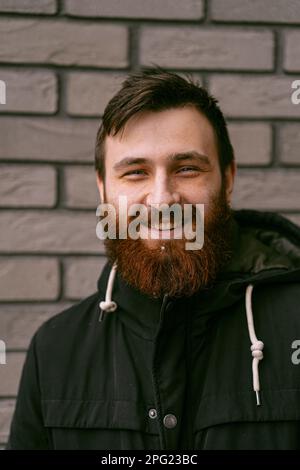 Emotional portrait of a handsome young man with red beard. Stock Photo