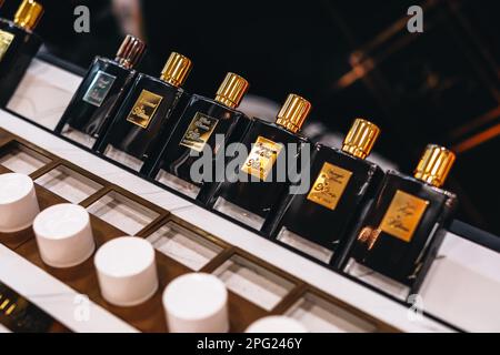 Premium Perfume Shop display. Golden black bottles Kilian fragrances in a shopping mall. Stock Photo
