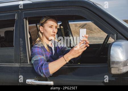 Woman taking a picture of Grand Canyon through the car window Stock Photo