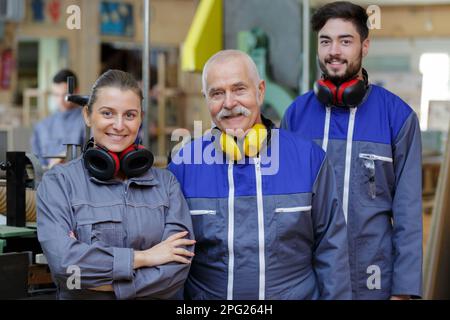 happy warehouse managers and worker standing together Stock Photo