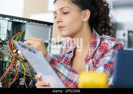 beautiful engineer with clipboard in server room Stock Photo