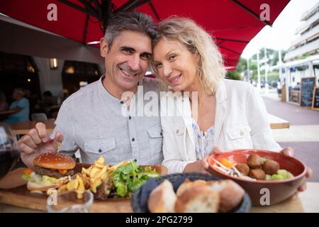 senior happy couple eating outdoors Stock Photo