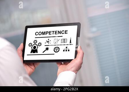 Competence concept shown on a tablet held by a man Stock Photo