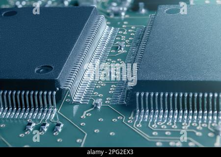 Closeup of Printed Circuit Board with processor, integrated circuits and many other surface mounted passive electrical components. Stock Photo