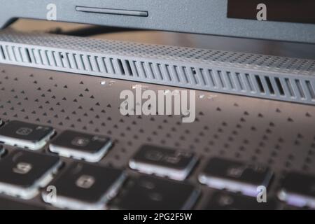 Laptop light indicators close-up . Gaming powerful grey notebook design elements. Tech, IT, electronics, computer science background Stock Photo